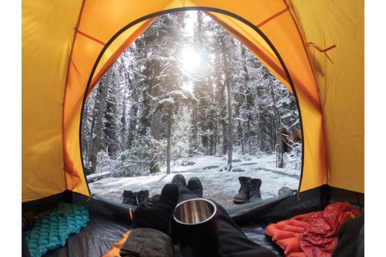 “Tent insulated with reflective mylar in snowy woods”